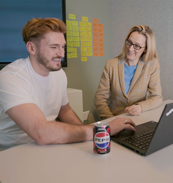 Employees working together at a computer